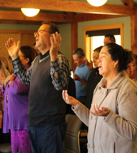 People worshiping with raised hands