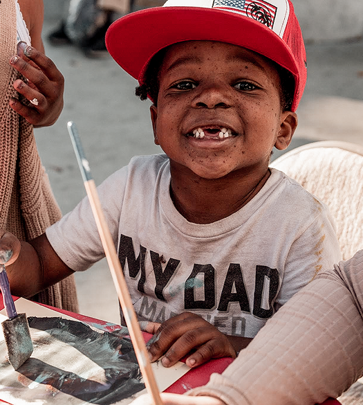 Smiling boy painting