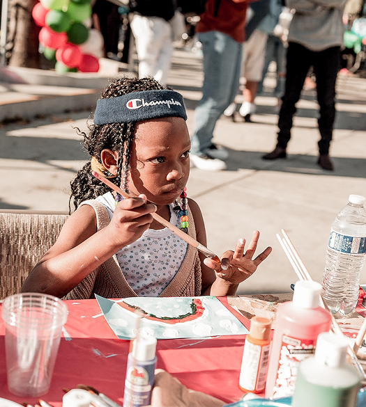 Young girl focused on painting