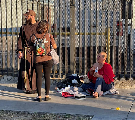 Friars and volunteers talking to people on the street