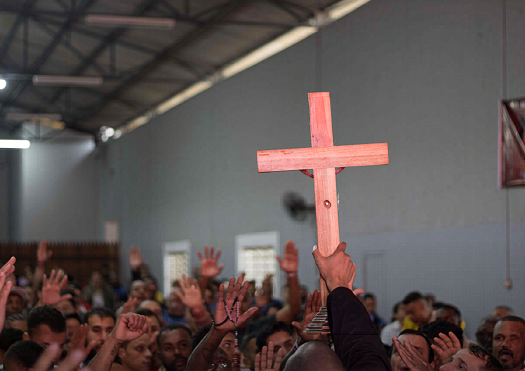 Holding up a wooden cross