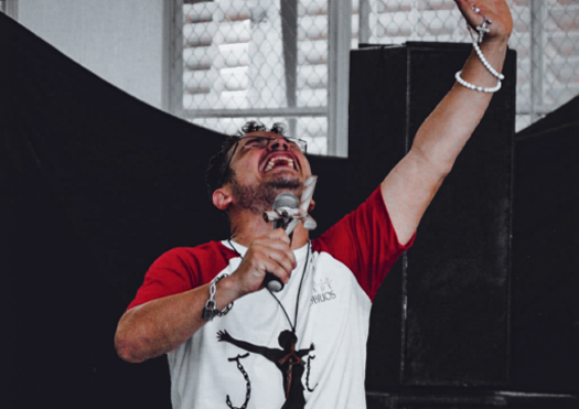 Man testifying or praying with a microphone