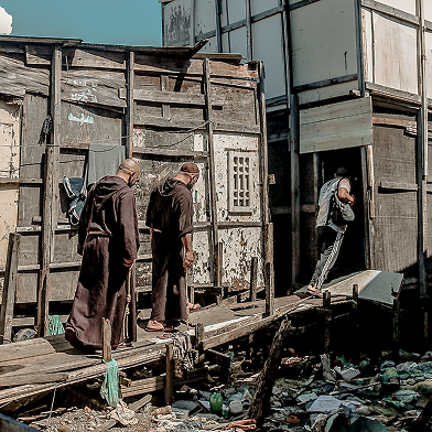 Friars walking on a wooden bridge